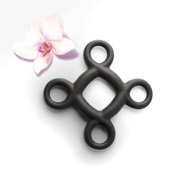 The Quest Elevate accessible cock ring. A black silicone cock ring with four finger rings evenly spaced around the edge of the ring.